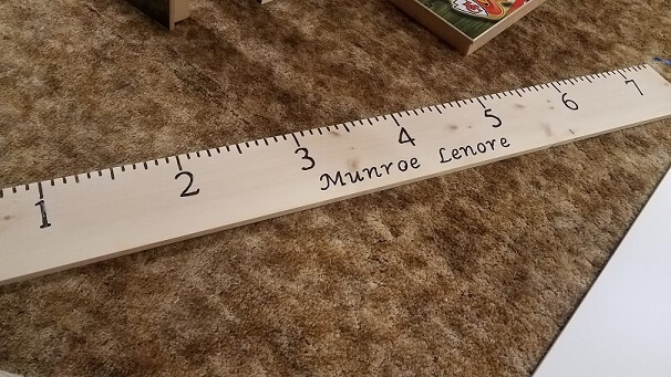 This 7 foot growth ruler is made out of solid pine wood measuring 0.75" thick, 9.25-9.5" wide, and 7' long.  Place it 1/2 foot off your floor and mark your childs height directly onto the ruler.  Include the childs name in the comments section when you or
